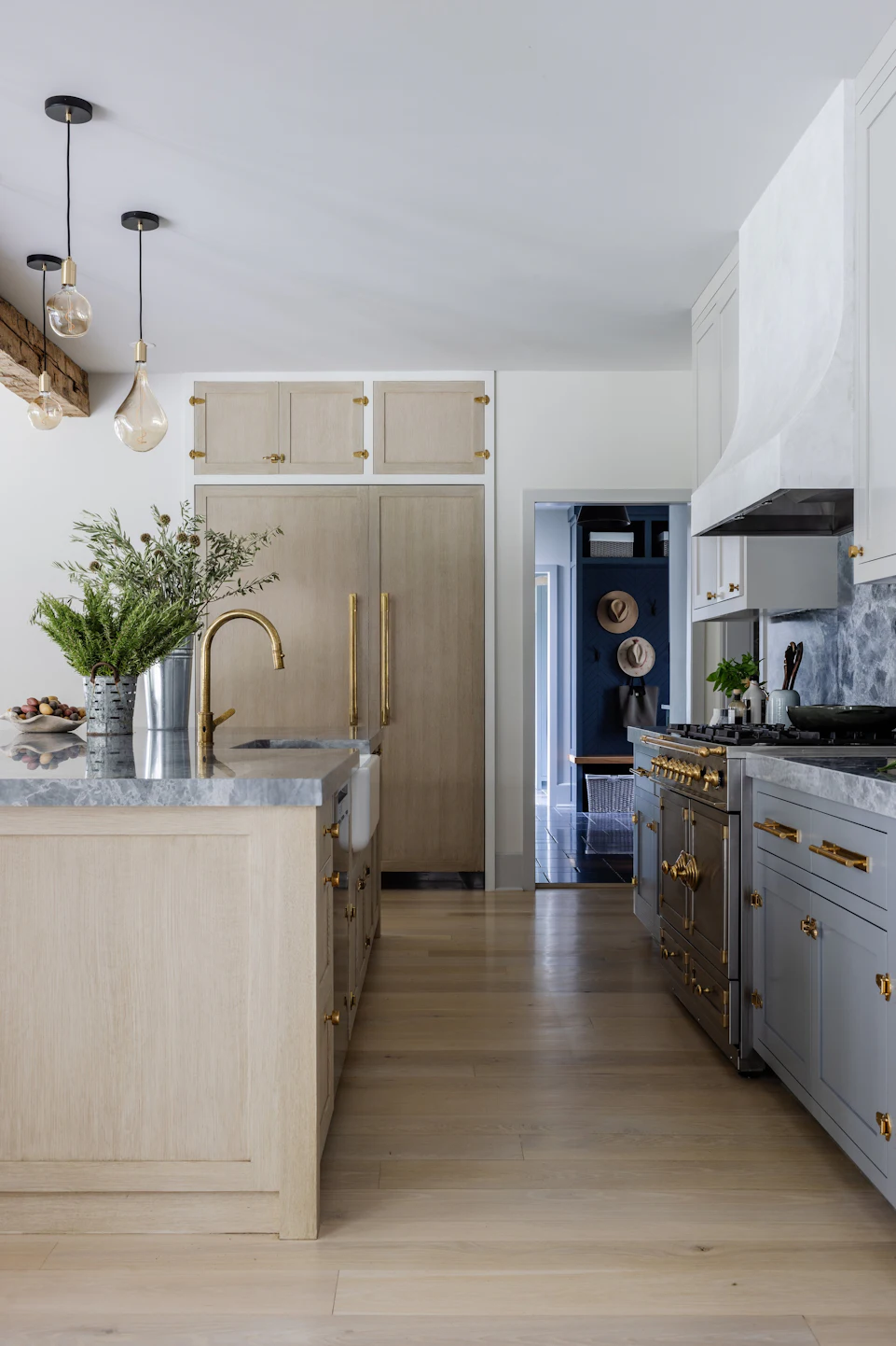 Custom kitchen view with La Cornue-style blue range, white oak cabinetry, brass hardware, and marble countertops in the Fairfield Transitional home