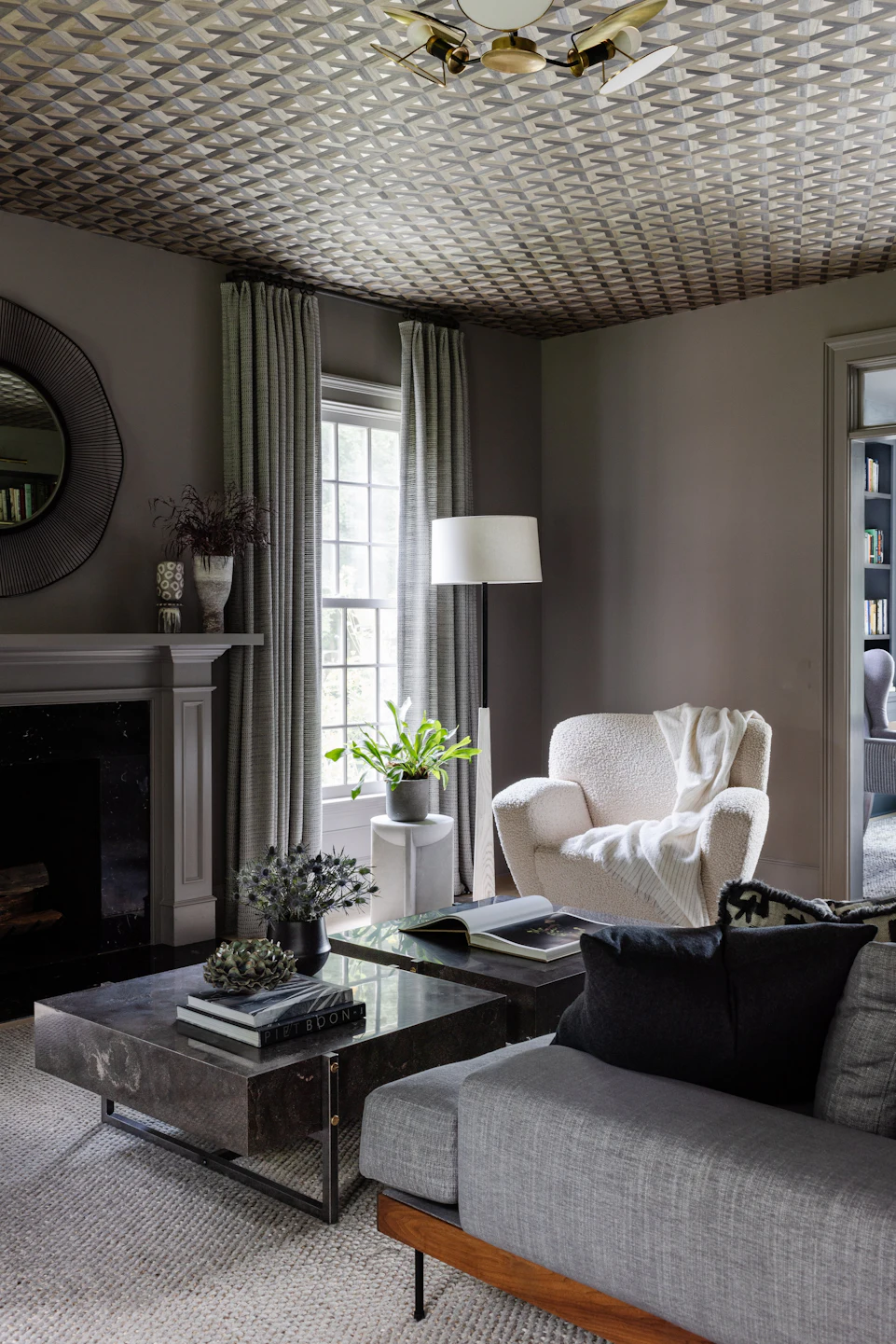 Formal sitting room with custom wallpapered ceiling, fireplace, and traditional millwork in the Fairfield Transitional custom home